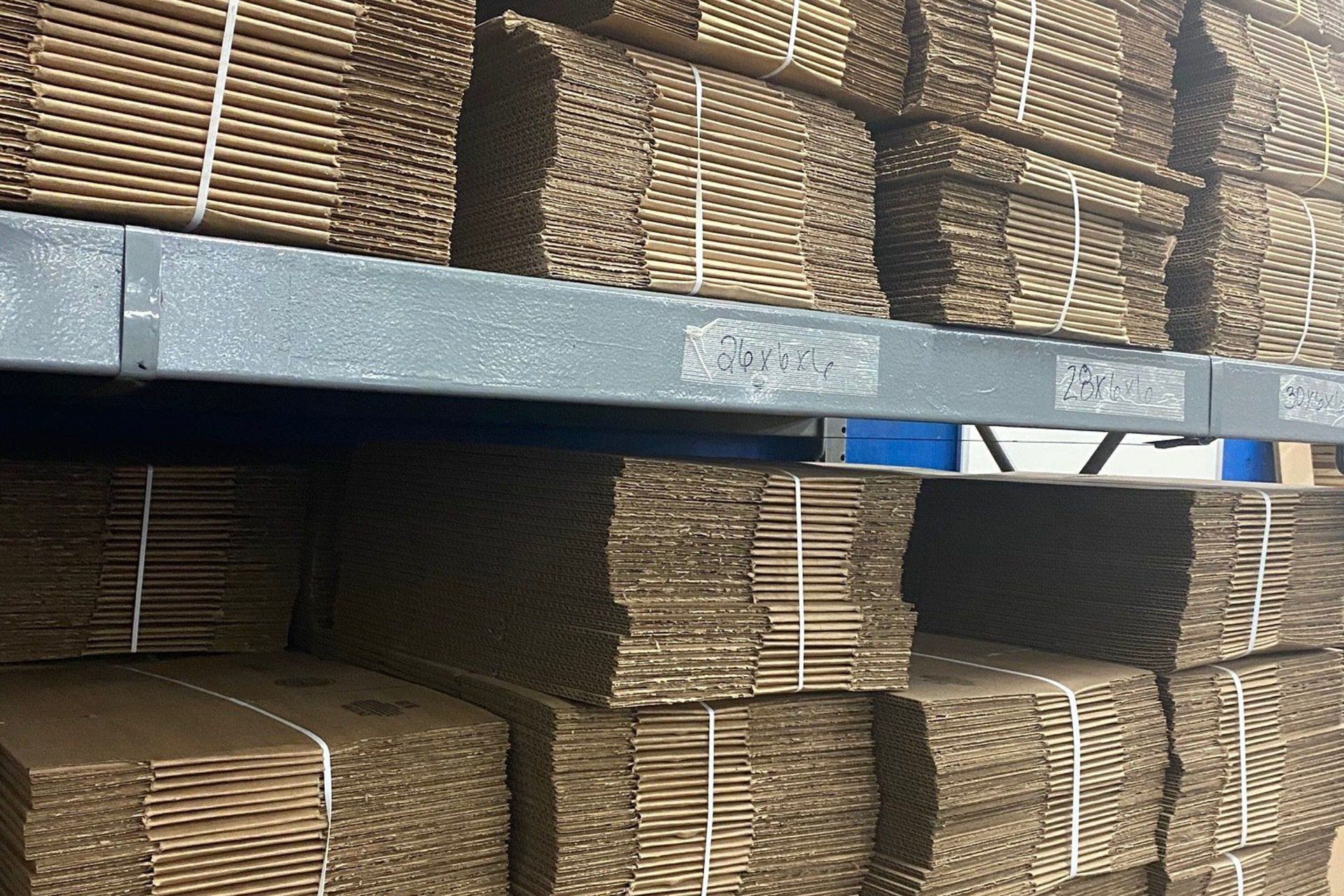 New cardboard boxes stacked on warehouse shelves