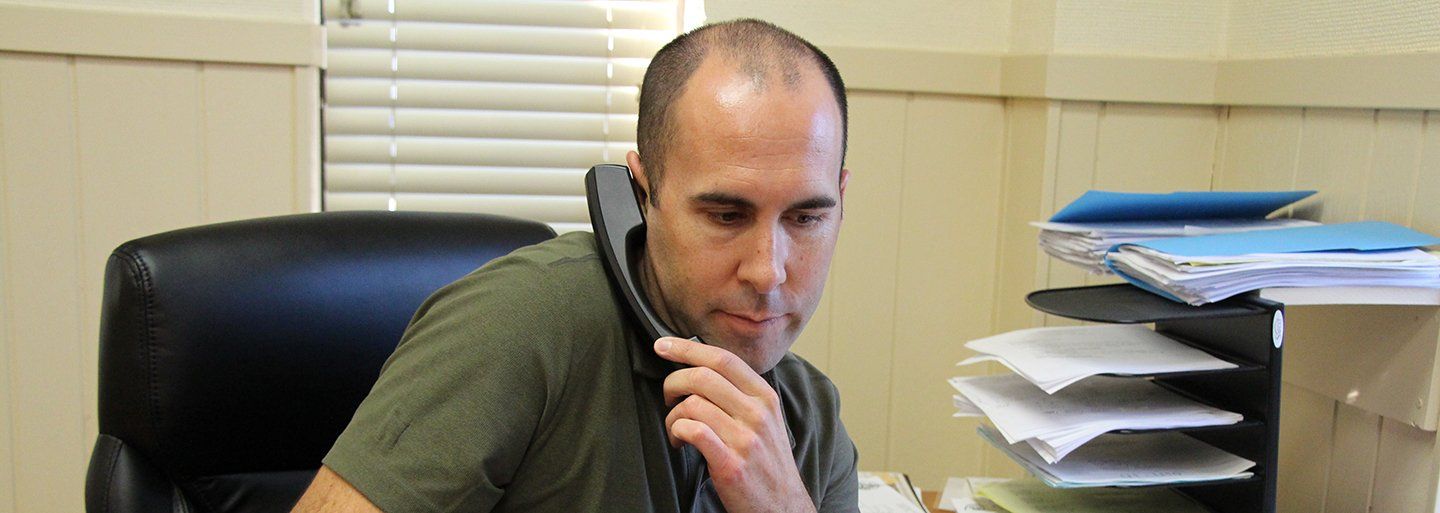 Ted Ladky of Rolled Threads Unlimited on the phone in his office