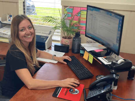 Kelly Rechlicz at desk