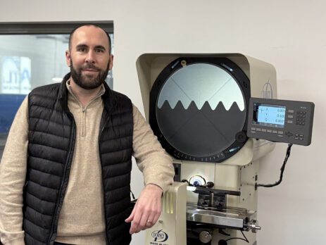 Ted Ladky standing next to machine