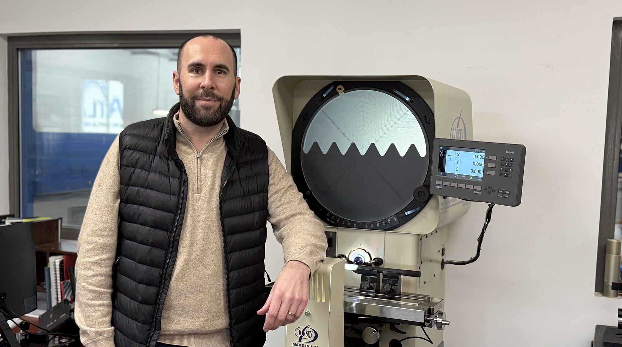 Ted Ladky standing next to machine